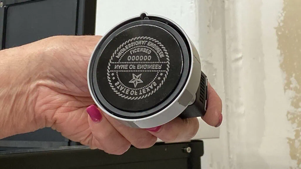 A person holding a black and white circular object, featuring Data Field Technology Services and highlighting their expertise in innovative tech solutions.