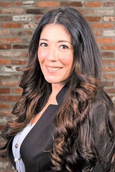 Portrait of a confident woman, with the logo of Datafield Technology Services visible in the background. The woman, identified as Jennifer Cassella, appears to be a key figure associated with the company.