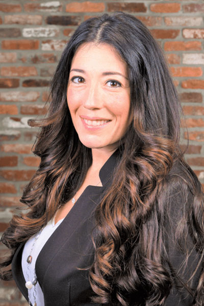 Portrait of a confident woman, with the logo of Datafield Technology Services visible in the background. The woman, identified as Jennifer Cassella, appears to be a key figure associated with the company.