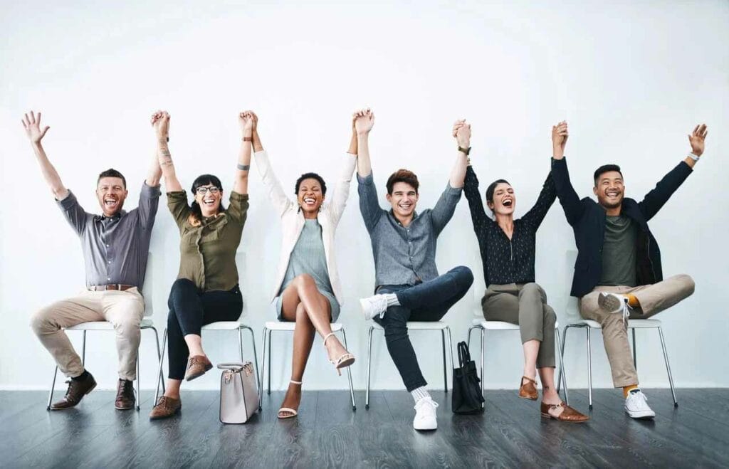 Group raising both hands up, featuring Datafield Technology Services, and highlighting The Key to Superior Staffing Solutions, perfectly aligned with the page's context.