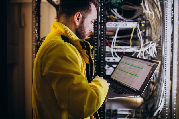 Man in yellow holding a tablet, featuring Datafield Technology Services, and spotlighting The Role of Cloud Computing in Telecom, seamlessly aligned with the page's context.